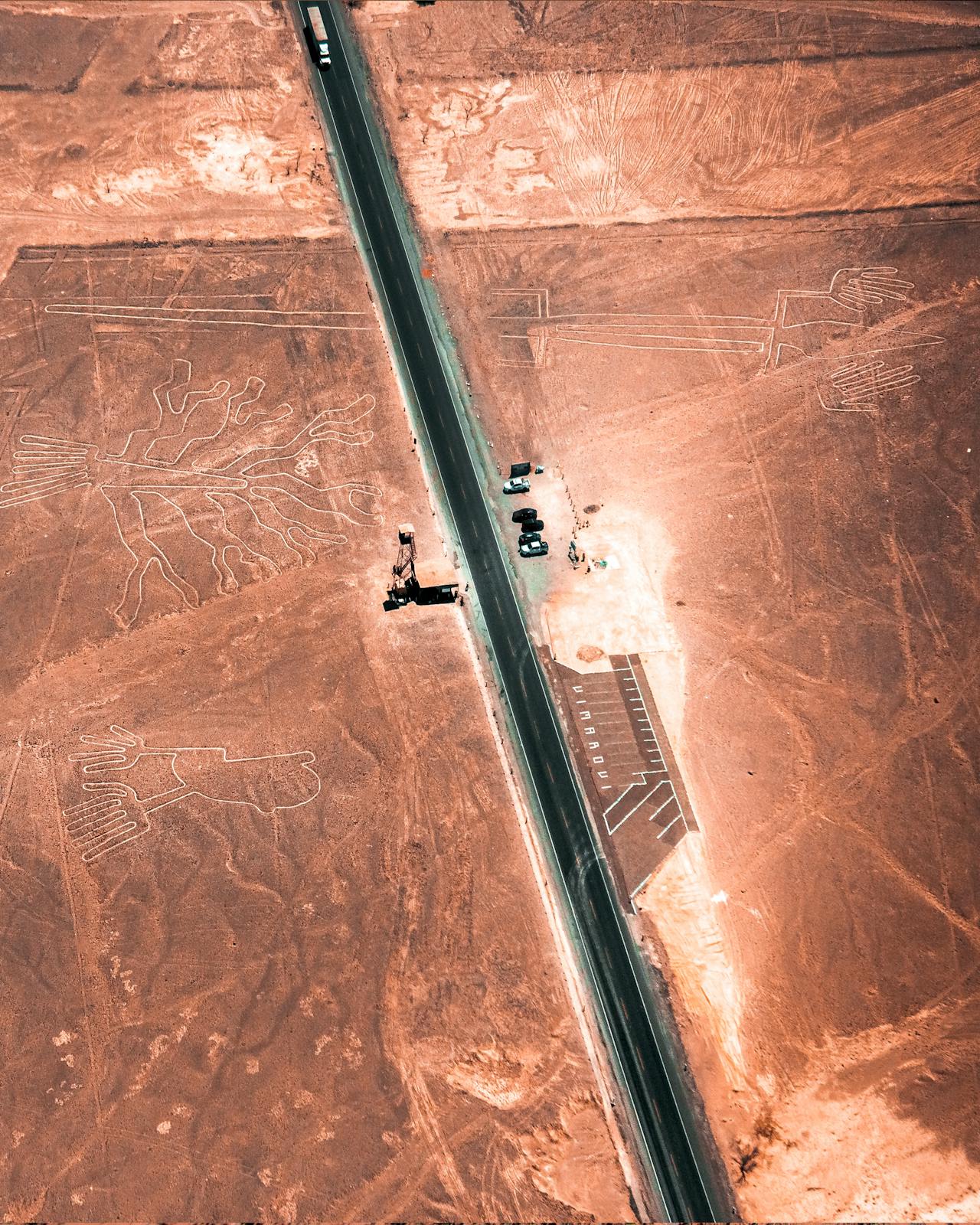“Aerial view of the Nazca Lines in Peru, showing ancient geoglyphs shaped like animals and plants.”