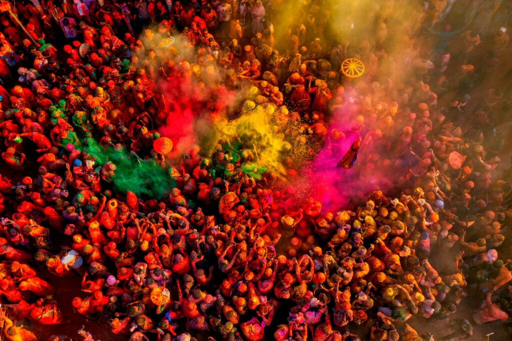 “Vibrant Holi festival in India with people throwing colorful powder.”
