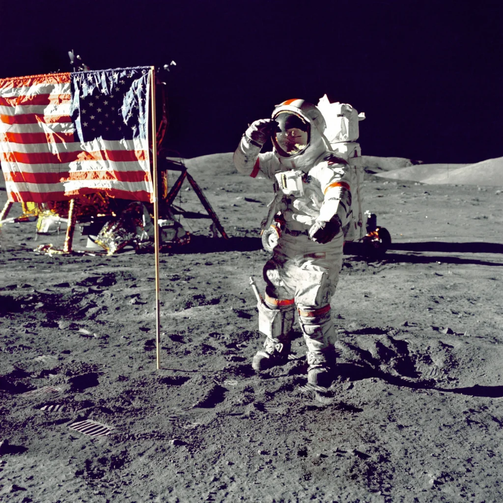 NASA astronaut standing on the Moon beside the American flag during Apollo 11 mission