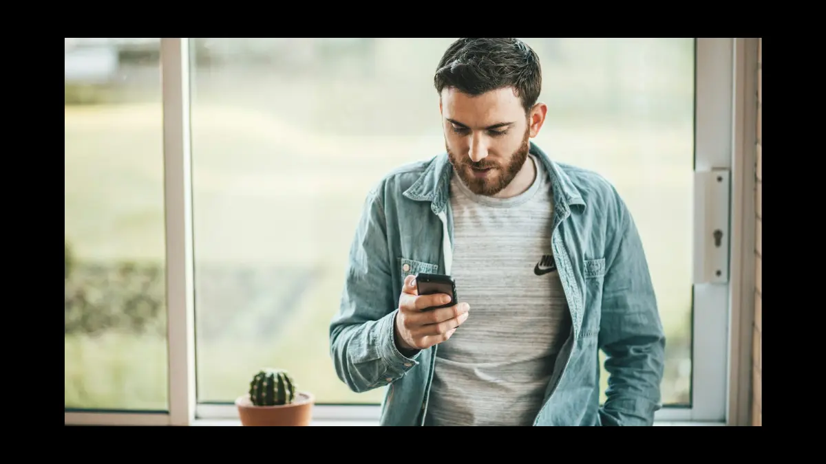 The Psychology of FOMO: Why We Fear Missing Out "Man with smartphone, symbolizing FOMO psychology."