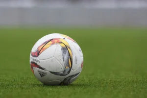 Cristiano Ronaldo success story starts with a simple ball on a field, representing his humble beginnings.