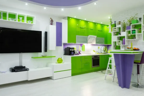 Unveil How Color Psychology Fights Digital Fatigue in 2025 “Modern kitchen with green cabinets and purple accents with TV showing color psychology for digital fatigue relief in 2025.”