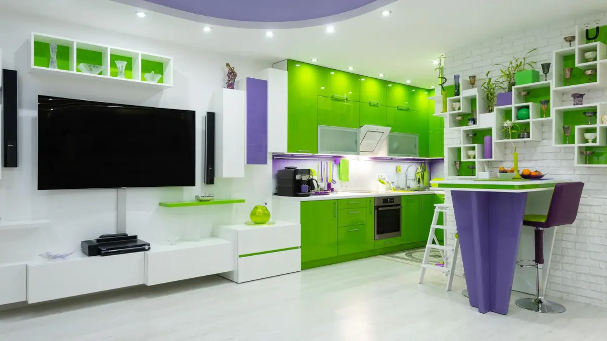 “Modern kitchen with green cabinets and purple accents with TV showing color psychology for digital fatigue relief in 2025.”