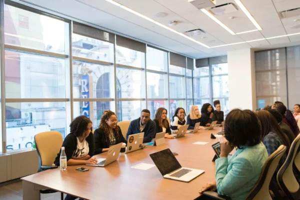 The Surprising Impact of Language Barriers in World Trade "Group of people with laptops facing language barriers in world trade during a business meeting."