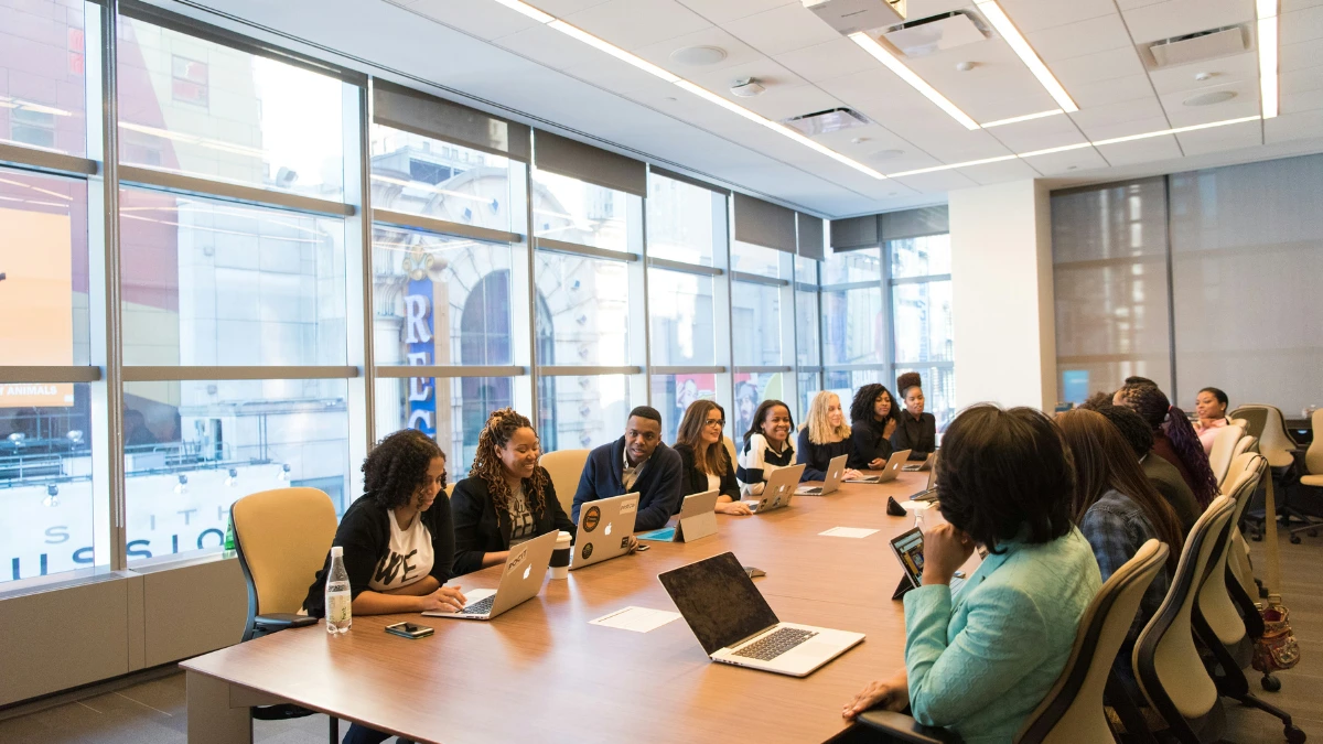 "Group of people with laptops facing language barriers in world trade during a business meeting."