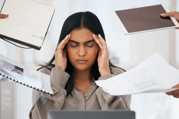 Why Multitasking Sabotages Your Brain (Fix It!) Stressed woman overwhelmed by the multitasking myth in office