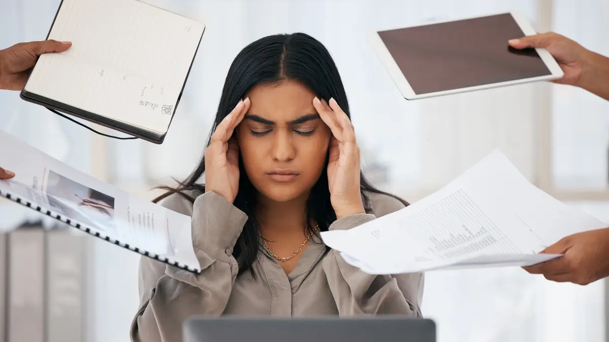 Stressed woman overwhelmed by the multitasking myth in office